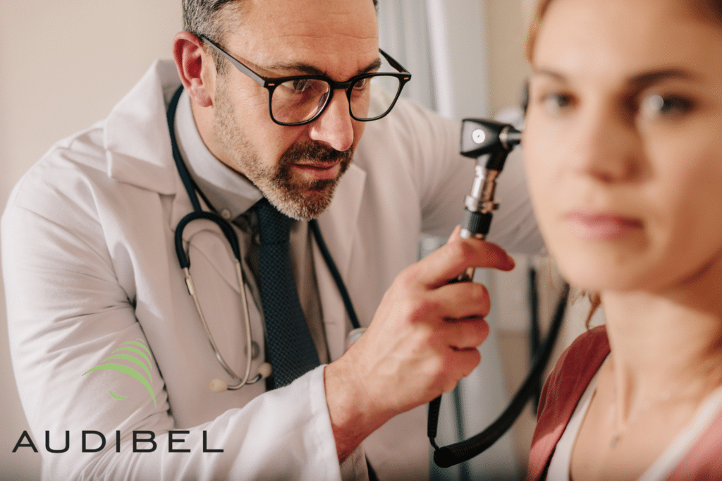 doctor looking in woman's ear