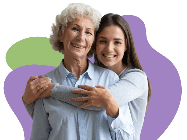 A mother and daughter stand together smiling