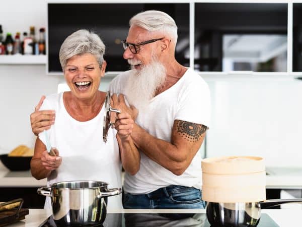 A couple has fun cooking in the kitchen together